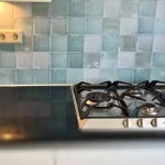 Antique tile backsplash kitchen with DW Solid splashback on the backsplash in combination with a gas stove.