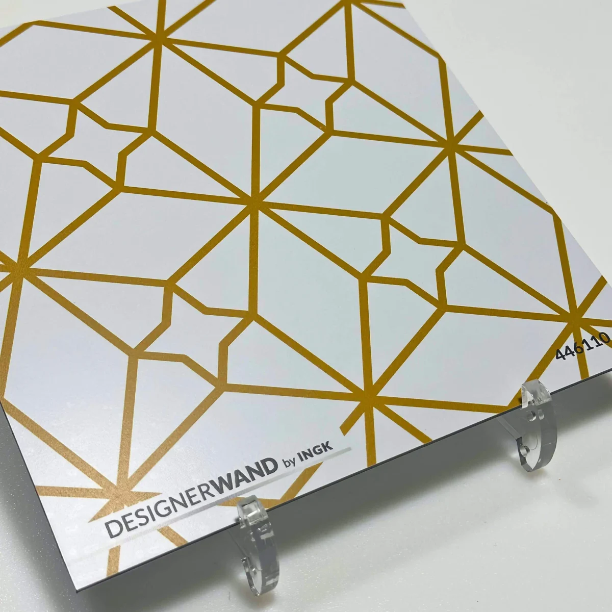 Échantillon de la crédence Fez Or avec motif étoilé géométrique en lignes dorées chaudes sur fond blanc