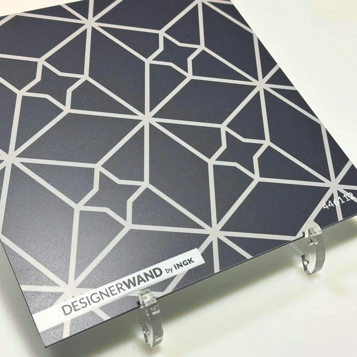 Sample of Fez Dark Silver backsplash with geometric star pattern in cool silver lines on dark background