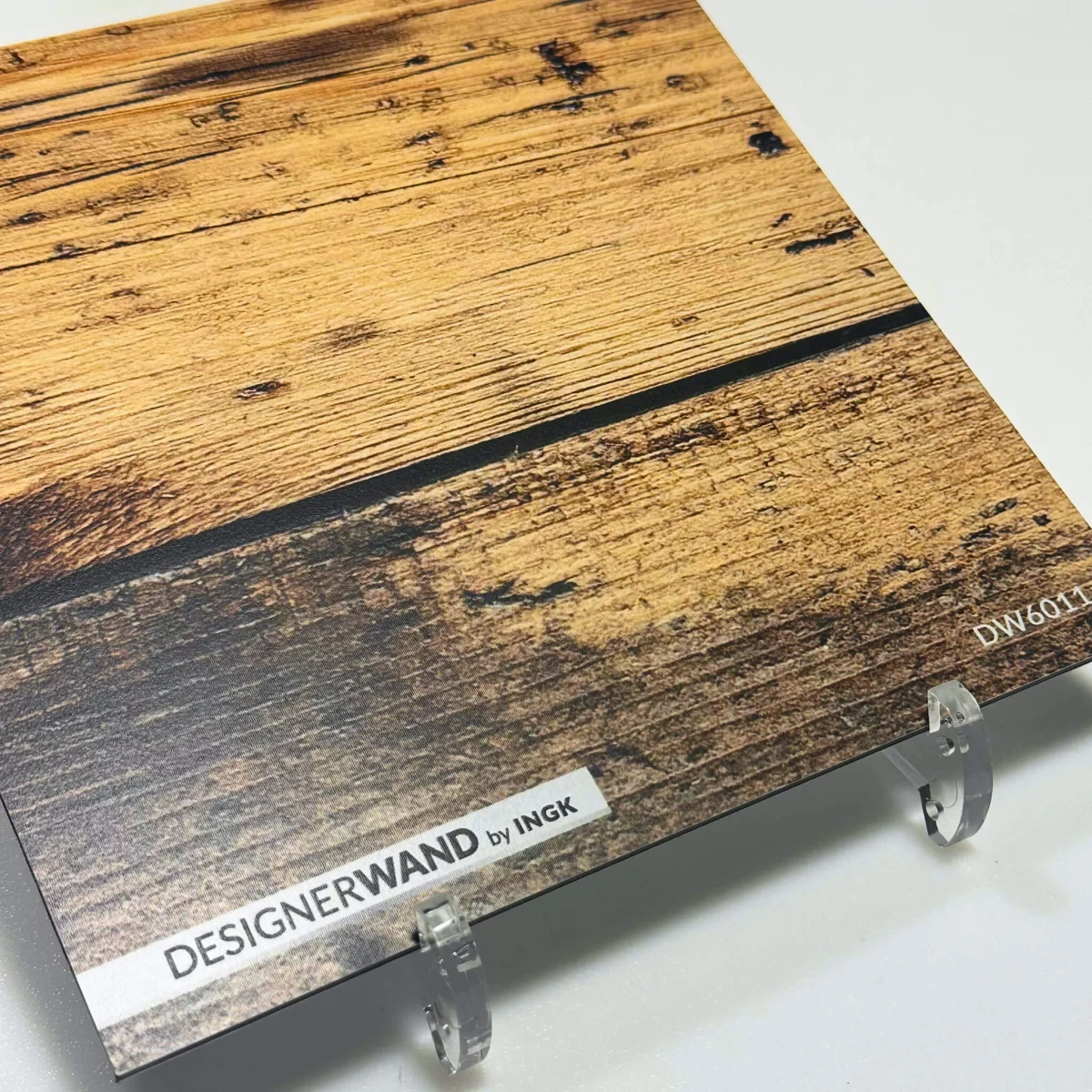 Sample of wooden backsplash DW6011 with broad rustic planks and visible knot holes in warm brown tones.