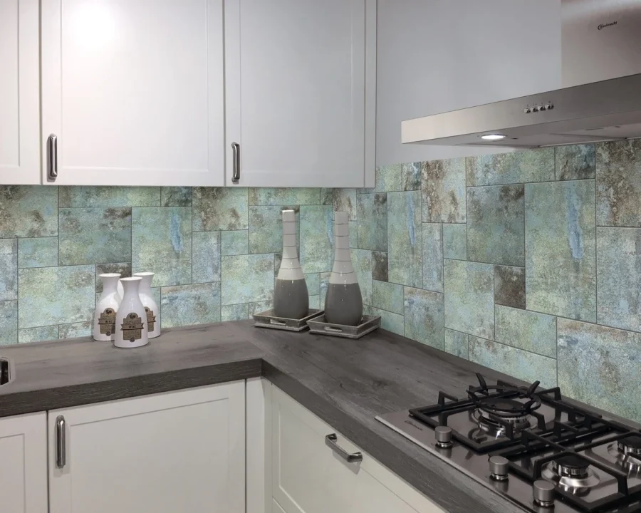 Industrial tile backsplash DW6015 with teal verdigris patina behind white kitchen