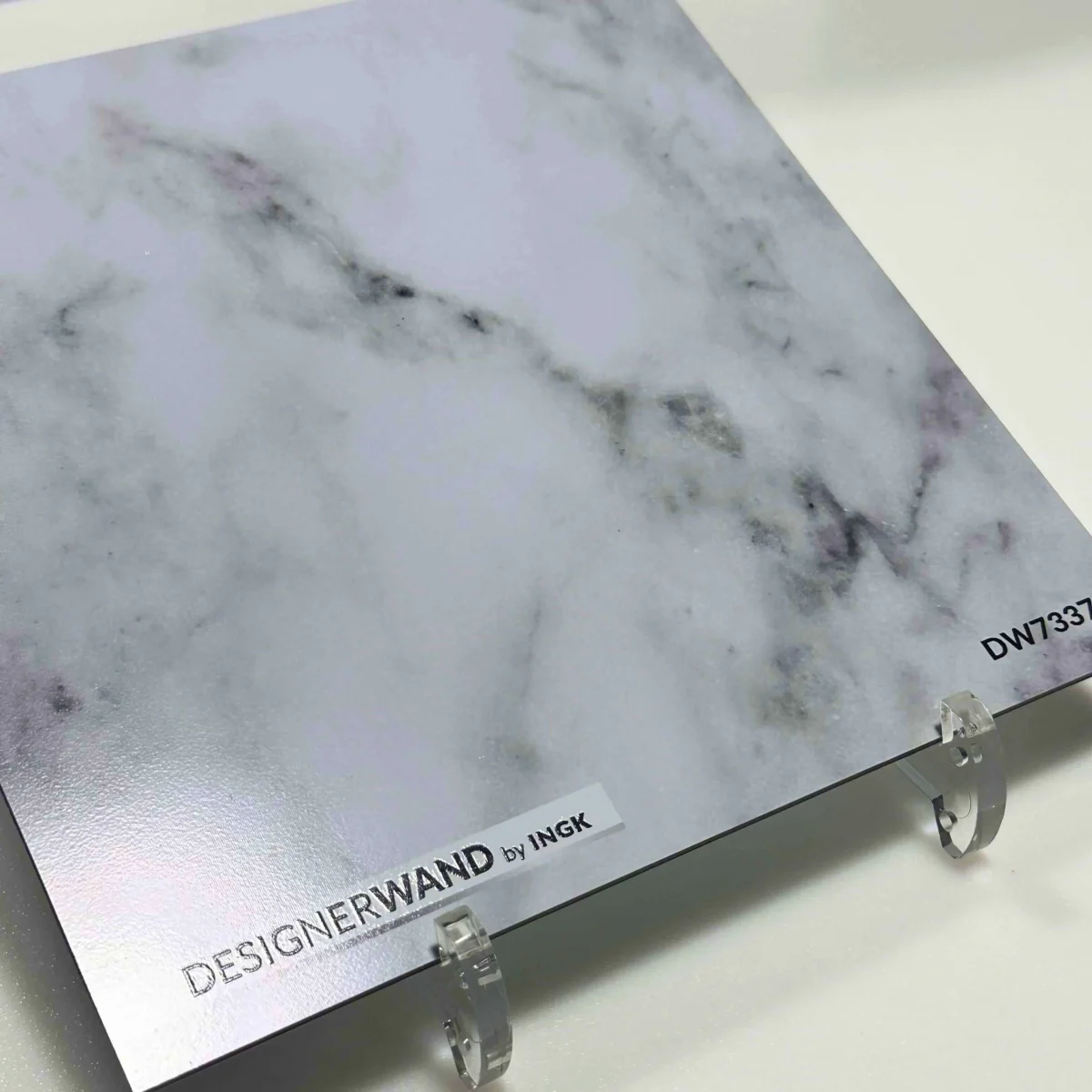 Sample of Marble Look backsplash DW7337 with classic Carrara veining on white surface