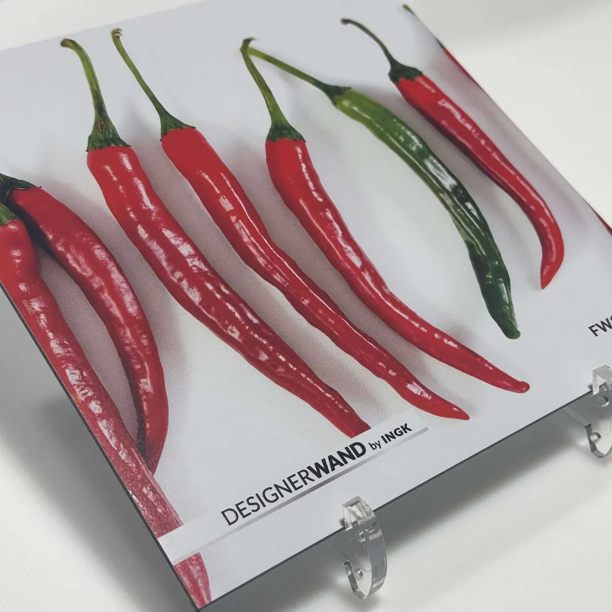 Sample of backsplash FW1010 with bright red and green chili peppers on white background